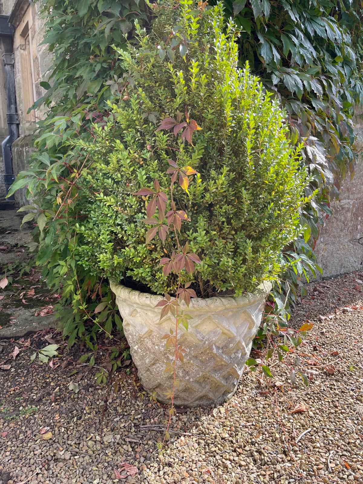 A set of four reconstituted stone garden vases